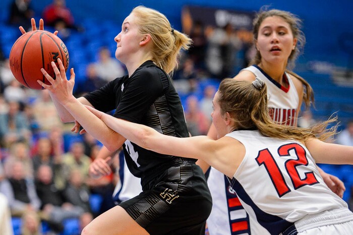 (Trent Nelson | The Salt Lake Tribune)  Highland's Olivia Beckstead (4) is fouled by Woods Cross's Paige McKenna (12) as Woods Cross faces Highland in the 5A High School Girls' Basketball Tournament at SLCC in Taylorsville, Wednesday Feb. 21, 2018.