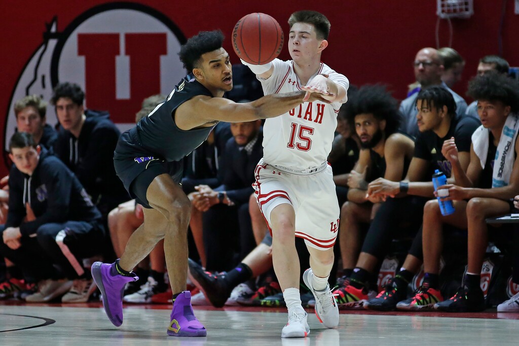 Washington guard Jamal Bey, left, guards Utah guard Rylan Jones, right, in the first half during an NCAA college basketball game Thursday, Jan. 23, 2020, in Salt Lake City. (AP Photo/Rick Bowmer)