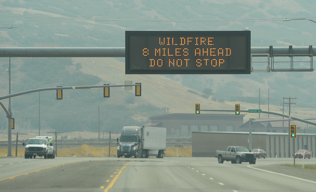 (Francisco Kjolseth  |  The Salt Lake Tribune)  Signs warn motorists of the Coal Hollow Fire burning along Highway 6 in Utah County, Saturday Aug. 11, 2018. 