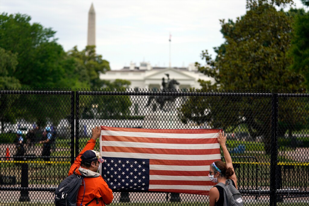 (Evan Vucci | AP file photo)  Demonstrators protest the death of George Floyd with an upside-down American flag, Tuesday, June 2, 2020, near the White House in Washington.