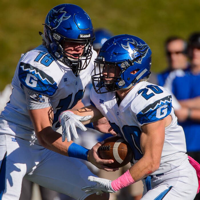 (Trent Nelson | The Salt Lake Tribune)
Pleasant Grove quarterback Jake Jensen (18) hands off to Dayne Christiansen (20) as East hosts Pleasant Grove in the first round of the 6A high school football playoffs, Friday Oct. 26, 2018.