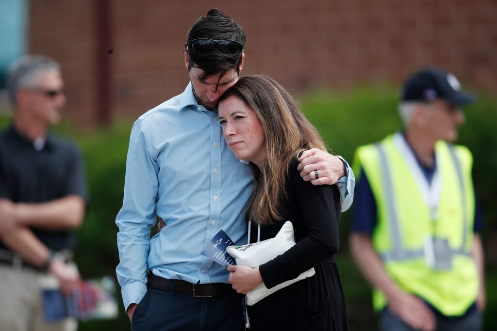 A young couple embrace after the memorial service for Kendrick Castillo, who was killed in the assault on the STEM Highlands Ranch School, Wednesday, May 15, 2019, in Highlands Ranch, Colo. (AP Photo/David Zalubowski)