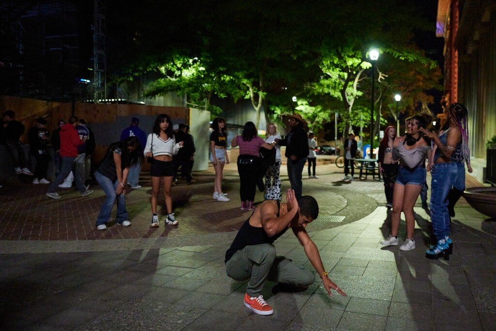 (Bridget Bennett | The New York Times) A sidewalk dance party in downtown Salt Lake City on Sept. 16, 2022. Salt Lake City’s downtown population is expected to double in the next two years, as residential towers, food halls and whiskey bars sprout against the backdrop of the Wasatch Mountains.