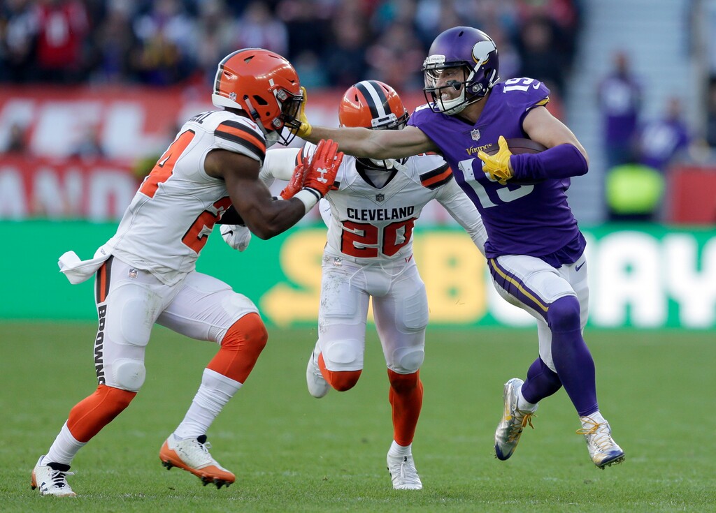 Minnesota Vikings wide receiver Adam Thielen, right, holds off Cleveland Browns' Ibraheim Campbell, left, and Briean Boddy-Calhoun (20) during the first half of an NFL football game at Twickenham Stadium in London, Sunday Oct. 29, 2017. (AP Photo/Tim Ireland)