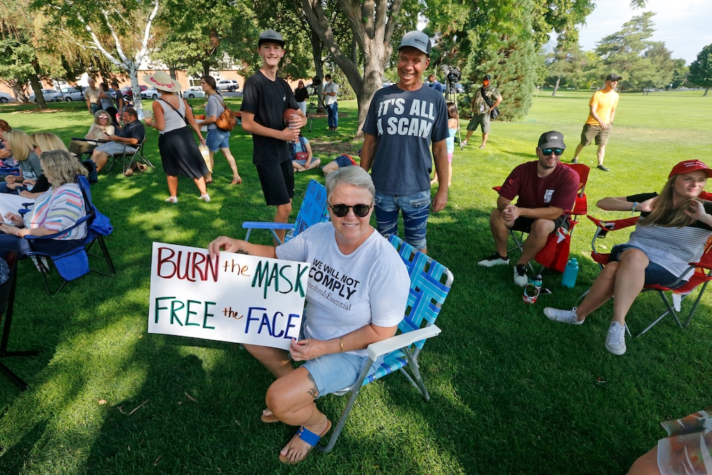 (AP file photo)Diann Bowen holds a "Burn the Mask, Free the Face" sign as she joins others during a rally Wednesday, Aug. 5, 2020, in Orem, Utah. In nearby Provo, the City Council approved a mask mandate, but the mayor plans to veto it.