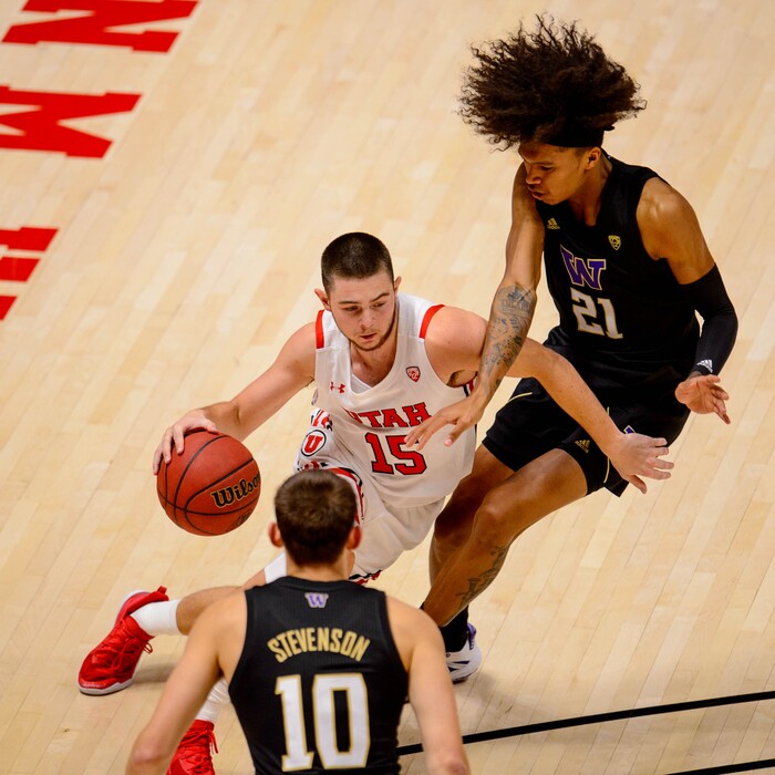 (Trent Nelson | The Salt Lake Tribune) Utah's Rylan Jones drives past Washington's Raequan Battle as Utah hosts Washington, NCAA basketball in Salt Lake City on Thursday, Dec. 3, 2020.
