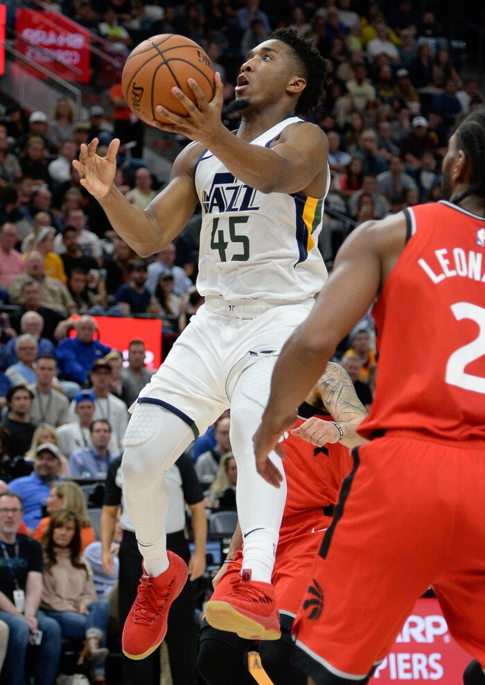 (Francisco Kjolseth  |  The Salt Lake Tribune)  Utah Jazz guard Donovan Mitchell (45) drives the ball past the Raptors in the first half of the preseason NBA game at Vivint Smart Home Arena Tuesday, Oct. 2, 2018, in Salt Lake City.