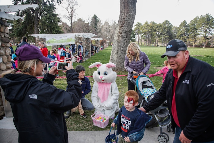 (Nicole Boliaux | For The Tribune) The Phillips family has their photo taken with the Easter Bunny during the annual Easter egg hunt put on by A Kid's Place Dentistry in Liberty Park in Salt Lake City on Saturday, March 31, 2018.