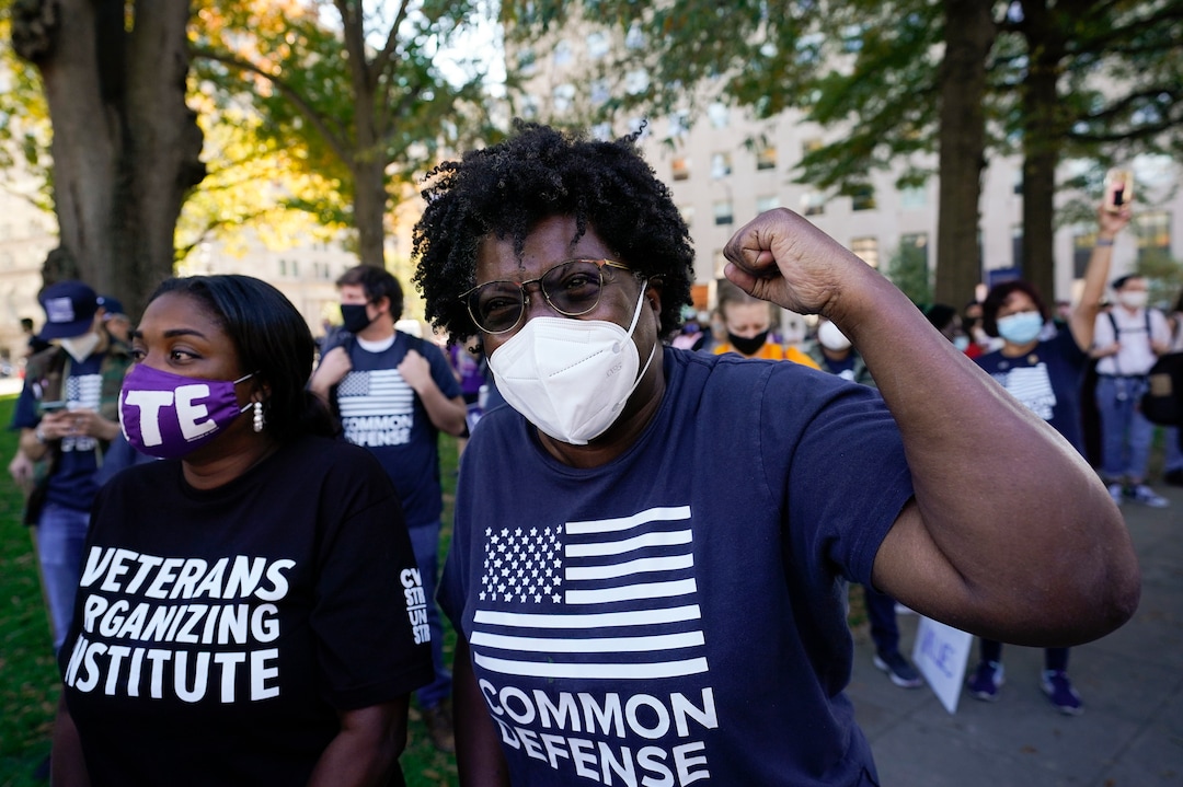 People gathered in Black Lives Matter Plaza, react to the presidential race being called in Joe Biden's favor, Saturday, Nov. 7, 2020, in Washington. Democrat Joe Biden has defeated President Donald Trump to become the 46th president of the United States.(AP Photo/Alex Brandon)