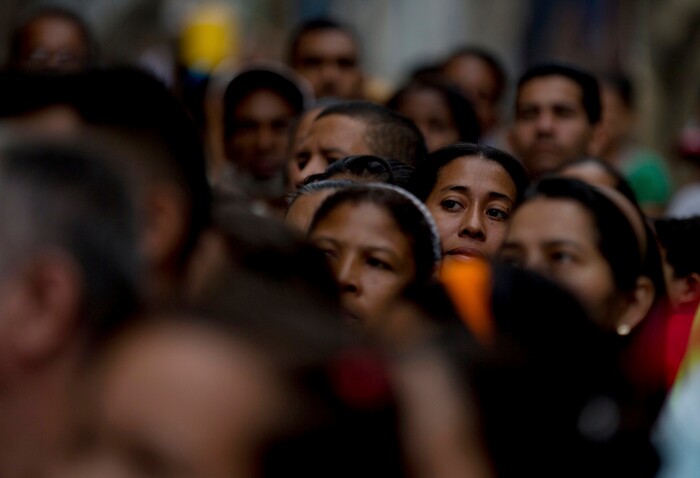Voters wait in line to cast their ballots outside a polling station during regional elections in Caracas, Venezuela, Sunday, Oct. 15, 2017. Elections could tilt a majority of the states' 23 governorships back into opposition control for the first time in nearly two decades of socialist party rule, though the government says the newly elected governors will be subordinate to a pro-government assembly.(AP Photo/Fernando Llano)