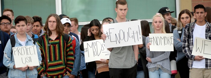 (Al Hartmann  |  The Salt Lake Tribune) 	
About 80 students at Westlake High School in Saratoga Springs left class and stood together in silence at the front entrance of the school Wednesday March 14, 2018 to remember the 17 students who died in a school shooting in Florida.  They held posters of the names of those killed. 