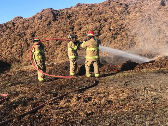 (Photo courtesy of the Juab County Fire District) Three Juab County Fire District firefighters working to put out a fire at the Young Living Lavender Farm in Mona. Fifteen firefighters responded to the report of a compost pile of Pinyon juniper spontaneously combusted.