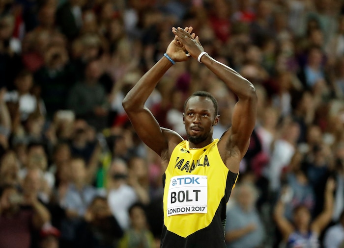 Jamaica's Usain Bolt greets his fans before a men's 100m heat during the World Athletics Championships in London Friday, Aug. 4, 2017. (AP Photo/Matt Dunham)
