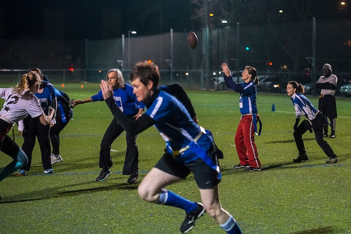 (Chris Detrick | The Salt Lake Tribune) Team A Lot quarterback Jenn Hartman takes the snap during the flag football team game against Sim Team at North University Fields in Provo Thursday, November 30, 2017.