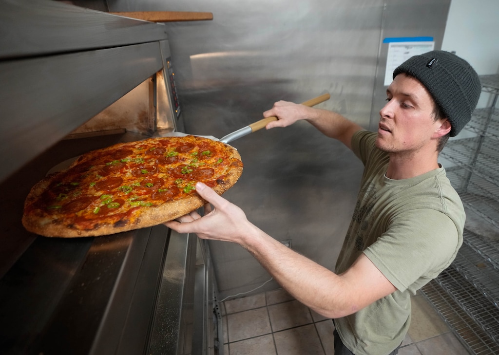 (Francisco Kjolseth | The Salt Lake Tribune) Sam Pew checks on a pie as he does Secret Pizza Club pop-up out of Leavity Bread & Coffee on Tuesday, October. 7, 2025.