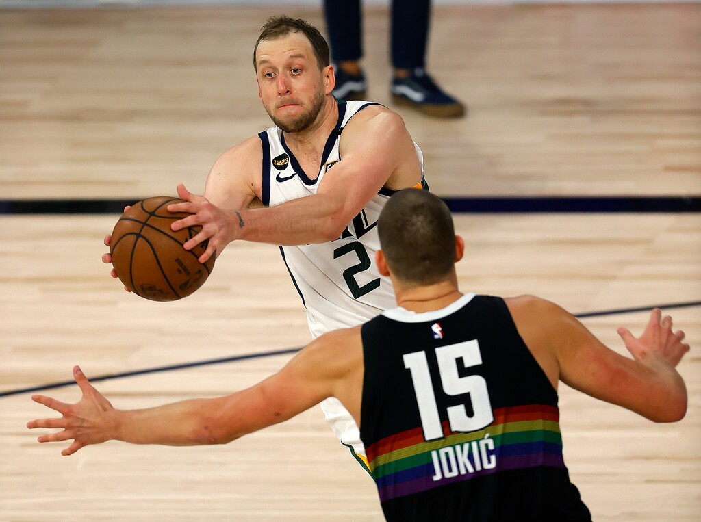 (Mike Ehrmann | Pool via AP) Utah Jazz's Joe Ingles passes the ball as Denver Nuggets' Nikola Jokic defends during the third quarter of Game 5 of an NBA basketball first-round playoff series, Tuesday, Aug. 25, 2020, in Lake Buena Vista, Fla.