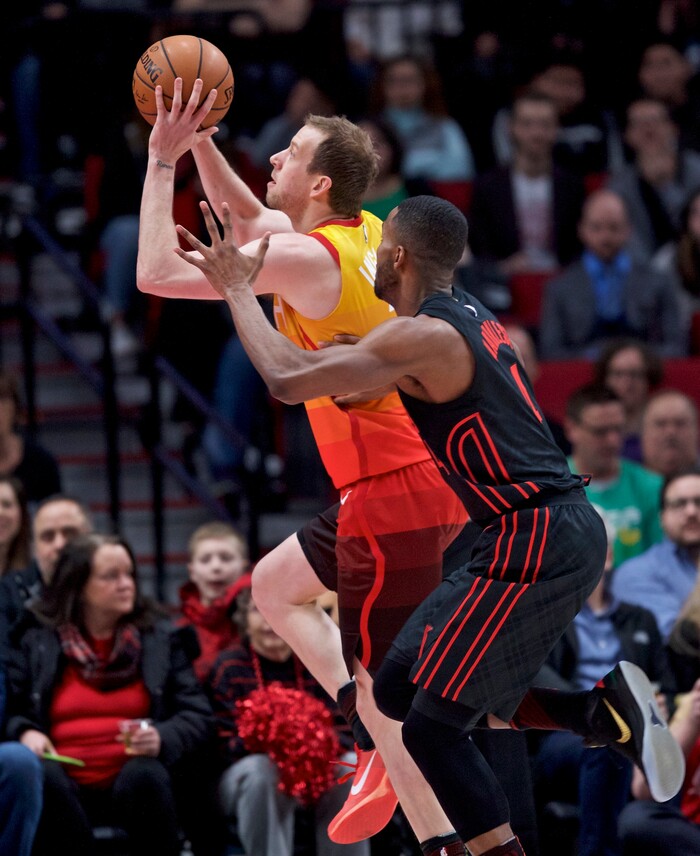 Utah Jazz forward Joe Ingles, left, shoots over Portland Trail Blazers forward Maurice Harkless during the first half of an NBA basketball game in Portland, Ore., Sunday, Feb. 11, 2018. (AP Photo/Craig Mitchelldyer)