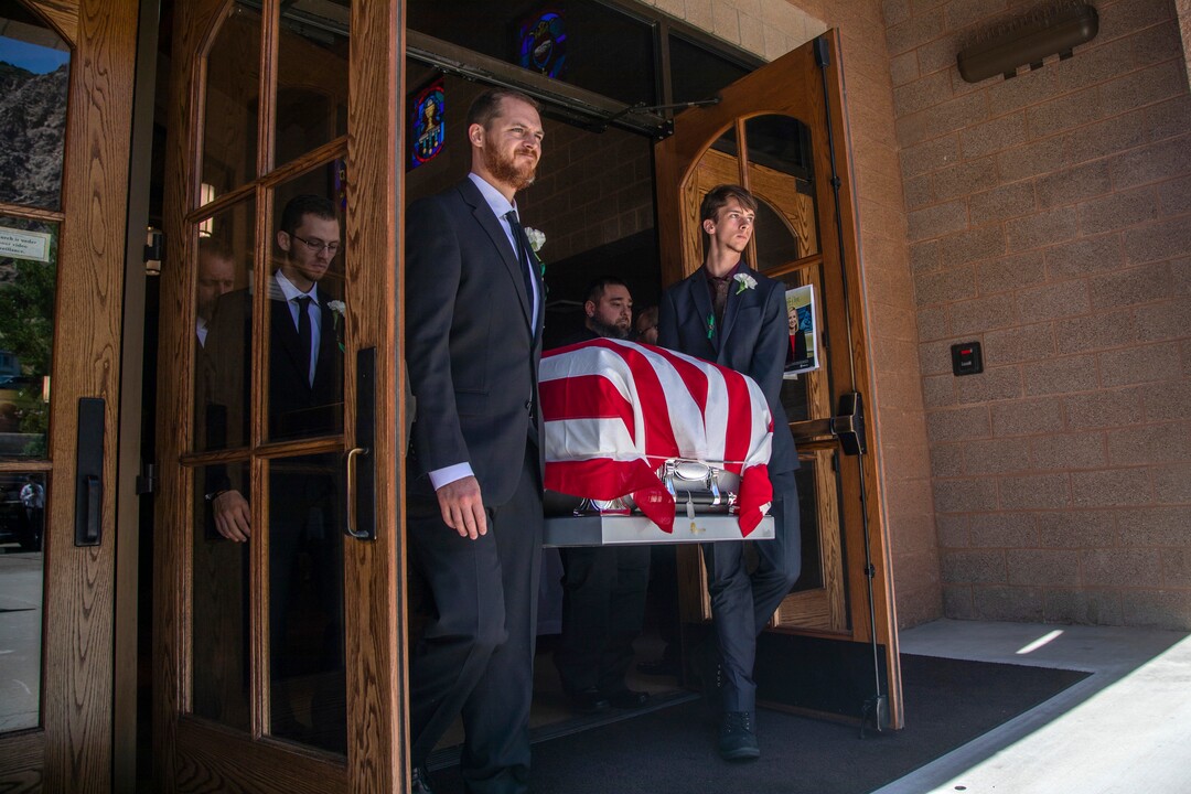 (Ben Dorger | Standard-Examiner via AP) Pallbearers carry the remains of Army Sgt. 1st Class Elliott Robbins on Thursday, July 18, 2019, at St. James Catholic Church in Ogden, Utah. Robbins died in a non-combat incident on June 30 while serving in Afghanistan.
