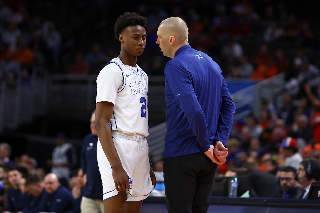 (John Peterson | AP) BYU head coach Mark Pope talks with guard Jaxson Robinson (2) in the second half of a first-round college basketball game against Duquesne in the NCAA Tournament, Thursday, March 21, 2024, in Omaha, Neb.