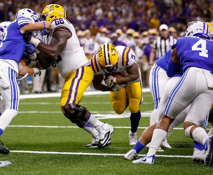 LSU running back Derrius Guice (5) scores his second touchdown against BYU in the first half of an NCAA college football game in New Orleans, Saturday, Sept. 2, 2017. (AP Photo/Scott Threlkeld)