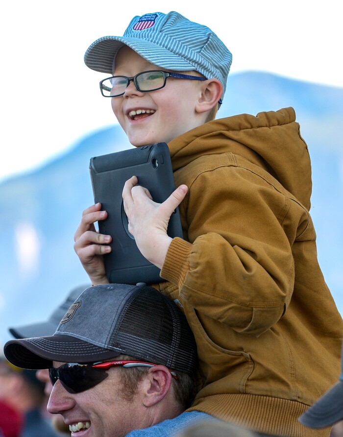 Leah Hogsten  |  The Salt Lake Tribune  Garrett Hess, 7, of Crescent, Illinois delights in the view he has atop his father, LanceÕs shoulders while watching the trains meet with GarrettÕs grandpa, great uncle and uncle. In celebration for the 150th anniversary of the transcontinental railroadÕs completion, Union Pacific's iconic steam locomotives, Living Legend No. 844 and Big Boy No. 4014 met at Ogden Union Station, May 9, 2019. 