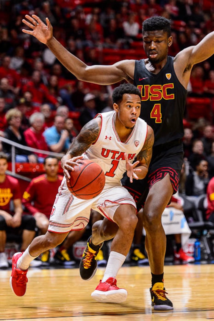 (Trent Nelson | The Salt Lake Tribune)  Utah Utes guard Justin Bibbins (1) drives on USC Trojans forward Chimezie Metu (4) as the University of Utah hosts USC, NCAA basketball at the Huntsman Center in Salt Lake City, Saturday Feb. 24, 2018.