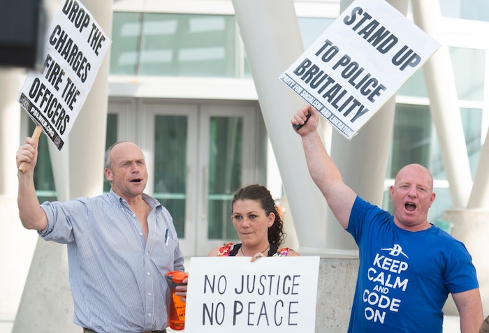(Rick Egan  |  The Salt Lake Tribune)     Protesters shout "stand up fight back" during a rally sponsored by Utah Against Police Brutality, which included several protesters that talked about their experience being attacked by Salt Lake City Policemen, at the Inland port protest.
Tuesday, July 23, 2019.