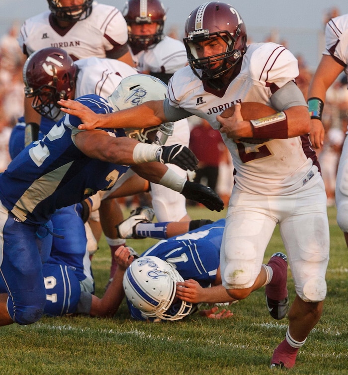 (Trent Nelson  |  The Salt Lake Tribune)  Jordan quarterback Austin Kafentzis runs for a second quarter touchdown as Fremont hosts Jordan High School football in Ogden, Utah Friday, August 17, 2012.