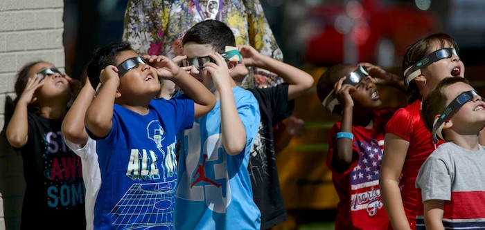 (Steve Griffin  |  The Salt Lake Tribune) Meadowlark Elementary School first-graders watch The Great Eclipse during the Salt Lake School District's first day of the 2017-2018 school year. STEAM teacher-coordinator Wendi Laurence who formerly worked at NASA has been planning an event around the eclipse. All students had glasses to view the event and many had lunch outside at the Salt Lake City school Monday August 21, 2017.