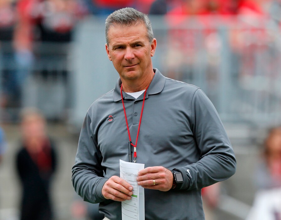 FILE - In this April 14, 2018, file photo, Ohio Setate coach Urban Meyer watches the NCAA college football team's spring game in Columbus, Ohio. Ohio State has placed Meyer on paid administrative leave while it investigates claims that his wife knew about allegations of abuse against an assistant coach years before he was fired last week. (AP Photo/Jay LaPrete, File)