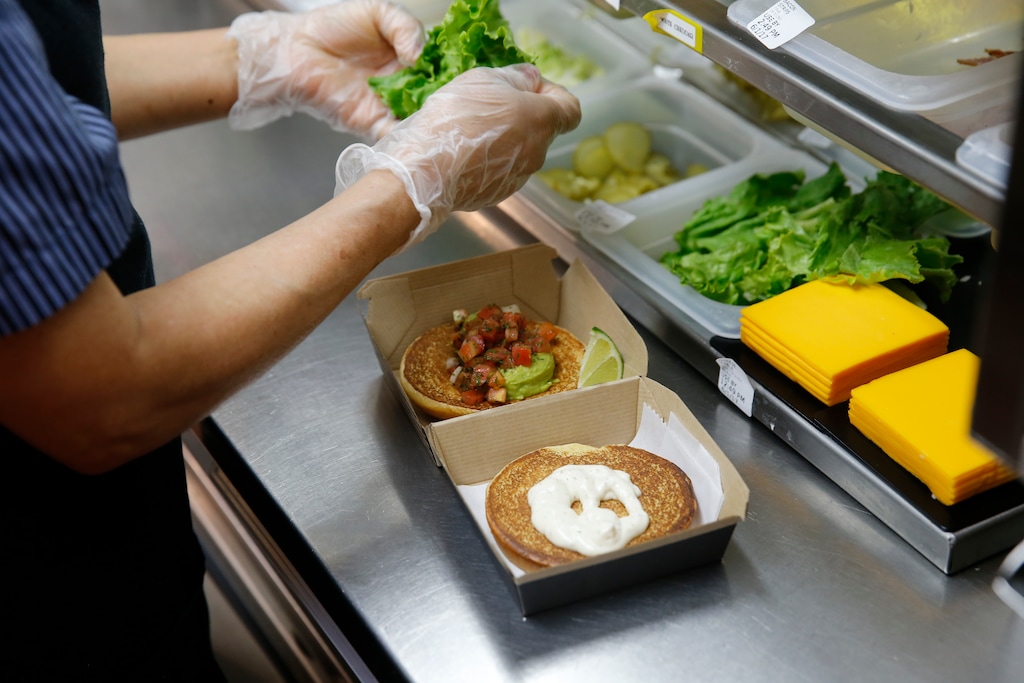 In this Thursday, June 1, 2017, photo, an employee prepares a specialty sandwich at a McDonald's restaurant in Chicago. (AP Photo/Charles Rex Arbogast)