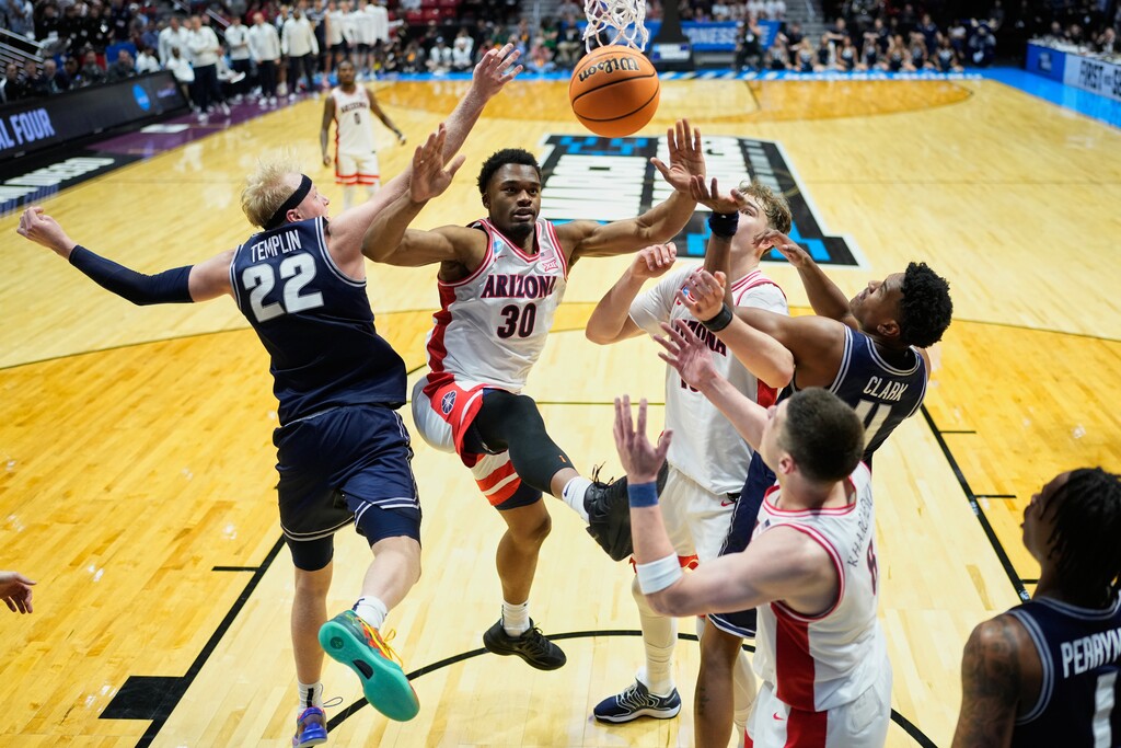 (Mark J. Terrill | AP) From left, Utah State forward Karson Templin (22), Arizona forward Tobe Awaka (30), Arizona center Motiejus Krivas (13) and Utah State forward Garry Clark, right, battle for the ball during the second half of a game in the second round of the NCAA college basketball tournament Sunday, March 22, 2026, in San Diego.