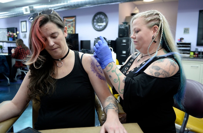 (Al Hartmann  |  The Salt Lake Tribune) 	
Terrina Francis, tatoo artist and owner of Fallen Angel Tattoo, is Salt Lake's only all-women tattoo studio.  She works on a personal tattoo for Shannon Gibbs, left.  The design is an old-fashioned cameo skull that she has thought about and wanted for four years.   Francis also offers to tattoo over scars and disfigurements due to domestic violence, breast cancer, and burns.   The shop offers a place where women can feel comfortable about getting tattooed in a very male-dominated field. 