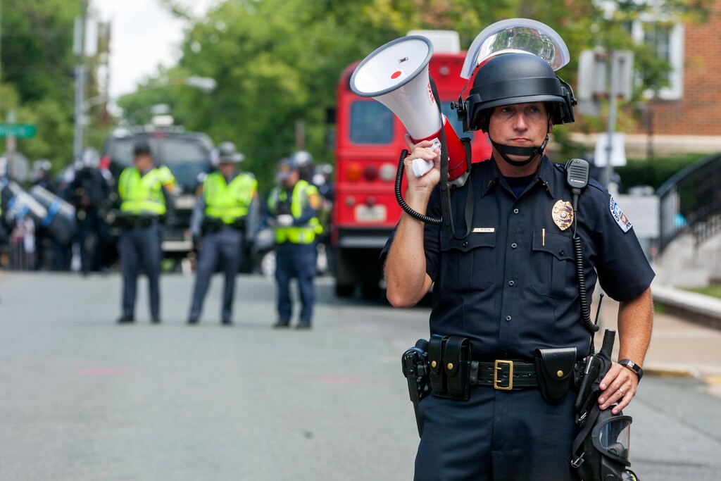 A police officer stands in the middle of the street after declaring the protest an unlawful assembly during a white nationalist rally, on Saturday Aug. 12, 2017, in Charlottesville, Va. (Shaban Athuman/Richmond Times-Dispatch via AP)