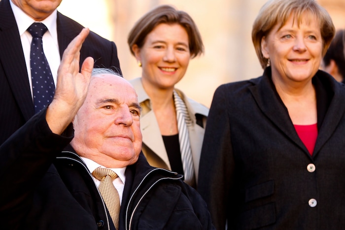 FILE - The Oct. 3, 2010 file photo shows former German Chancellor Helmut Kohl, left, waveing to audience as he arrives with his wife Maike Kohl-Richter, center, and Chancellor Angela Merkel, right, at the Reichstag building in Berlin, prior to the celebrations marking the 20th anniversary of Germany's reunification. (AP Photo/Markus Schreiber, file)