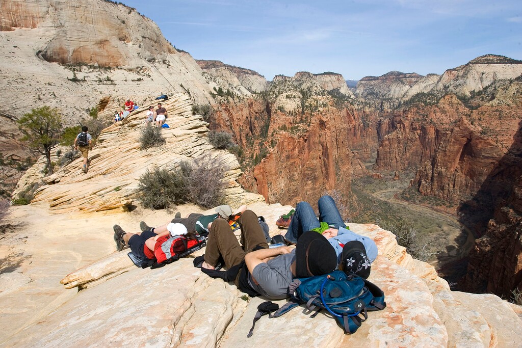 (Al Hartmann | Tribune File Photo) Hikers take a well-deserved rest at the top of Angels Landing Trail in Zion National Park in 2009.