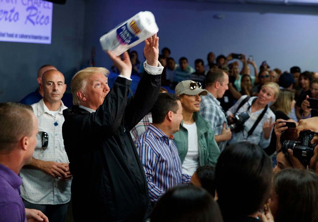 2017 AP YEAR END PHOTOS - President Donald Trump tosses paper towels into a crowd at Calvary Chapel in Guaynabo, Puerto Rico, on Oct. 3, 2017. Trump helped sink Puerto Ricans bond prices with talk of wiping out the U.S. territory's debt but his budget director dismissed the idea of a bailout as the bankrupt island fights to recover from Hurricane Maria. (AP Photo/Evan Vucci)