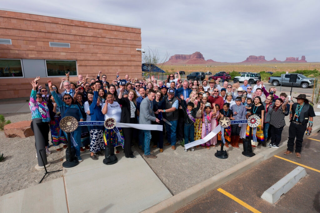 (Levi Sim | Utah State University) Community members, students and officials gather April 22 for a ribbon-cutting ceremony marking the opening of Utah State University’s new education building in Monument Valley, part of the Navajo Nation in southeastern Utah.