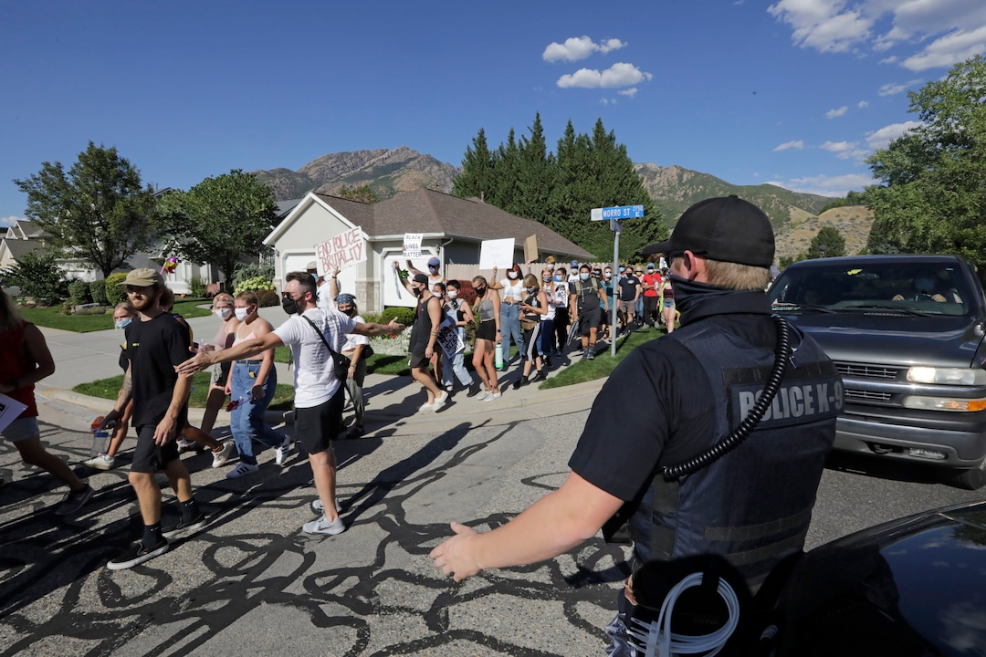 Protesters march Sunday, Aug. 2, 2020, in Cottonwood Heights, Utah. The protest was a "March for Justice" focused largely around Zane James, fatally shot by police in Cottonwood Heights in 2018. (AP Photo/Rick Bowmer)