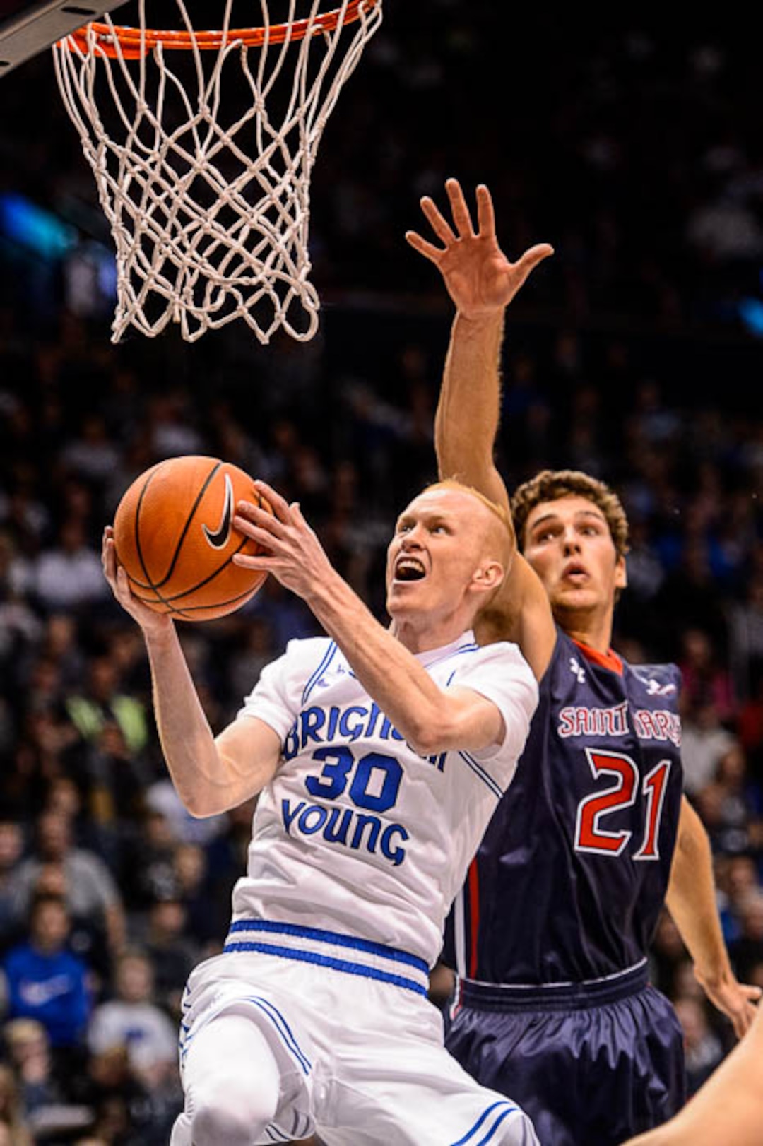(Trent Nelson | The Salt Lake Tribune)   Brigham Young Cougars guard TJ Haws (30) drives past St. Mary's Gaels center Evan Fitzner (21) as BYU hosts the St. Mary's Gaels, NCAA basketball in Provo, Saturday December 30, 2017.
