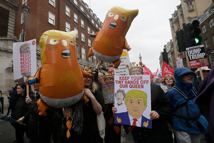 People carry signs and banners as they march through central London to demonstrate against the state visit of President Donald Trump, Tuesday, June 4, 2019. Trump will turn from pageantry to policy Tuesday as he joins British Prime Minister Theresa May for a day of talks likely to highlight fresh uncertainty in the allies' storied relationship. (AP Photo/Tim Ireland)