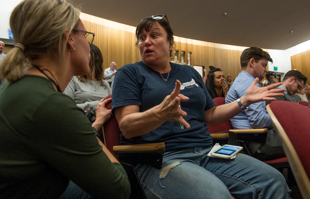 (Leah Hogsten  |  The Salt Lake Tribune) Michelle Goldberg (right) expresses her disbelief to neighbor Jennifer Luft during the public hearing that the Homeless Resource Center located at 275 W High Ave. would be located right across from her dog daycare business. Salt Lake City community leaders and service providers hosted a public forum, Tuesday, September 26, 2017 to present preliminary designs and programming for the two new Homeless Resource Centers to be located at 131 E 700 S and 275 W High Ave. in Salt Lake City. 