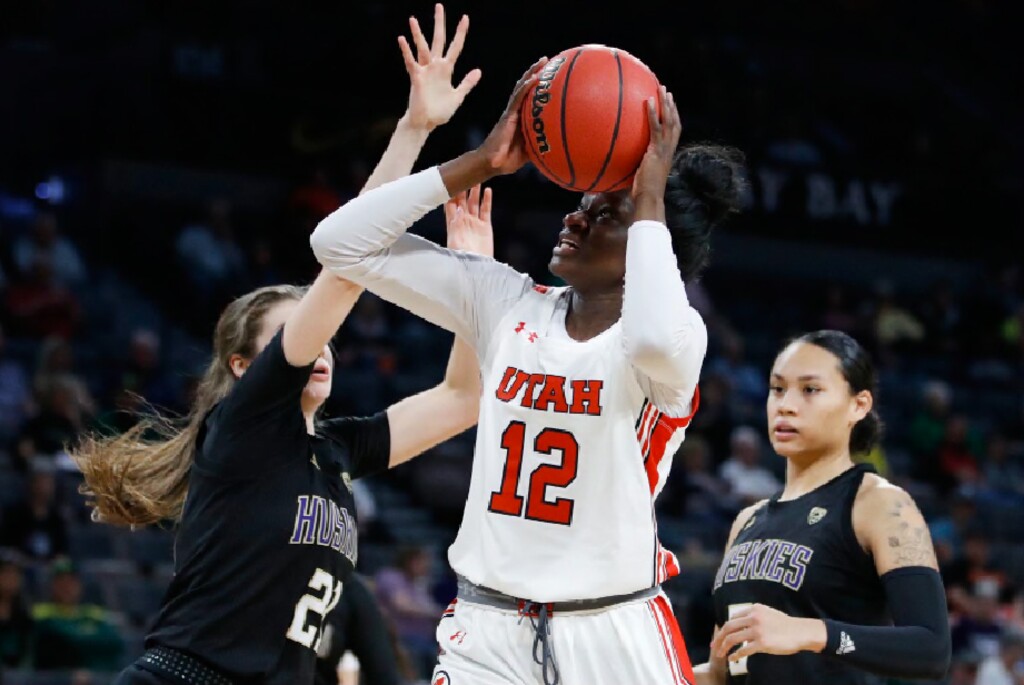 Utah's Lola Pendande (12) shoots over Washington's Rita Pleskevich (21) during the second half of an NCAA college basketball game in the first round of the Pac-12 women's tournament Thursday, March 5, 2020, in Las Vegas. (AP Photo/John Locher)