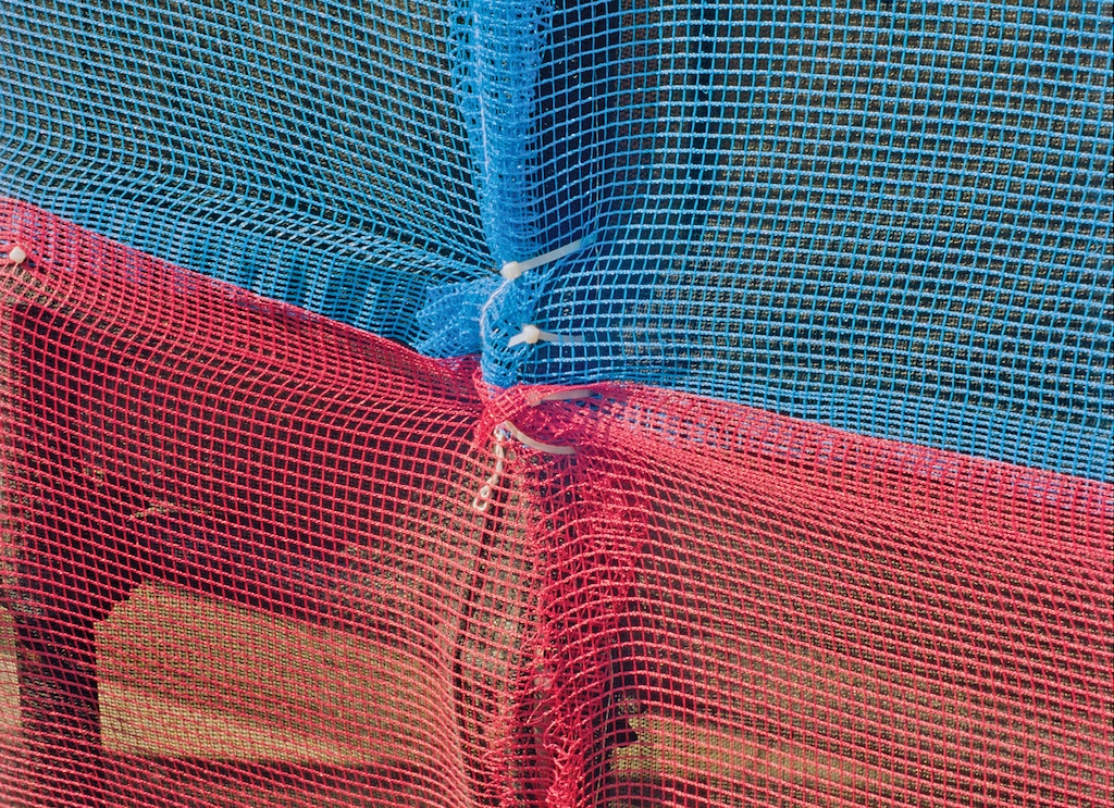 Patriotic netting stretched over construction scaffolding in Washington on July 4, 2026. (Gregory Halpern/The New York Times)