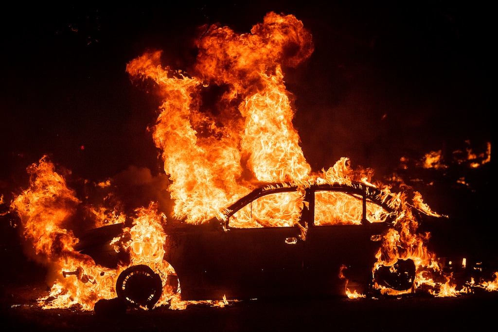 (Noah Berger | AP file photo) Flames from the Kincade Fire consume a car in the Jimtown community of unincorporated Sonoma County, Calif., on Thursday, Oct. 24, 2019. Wildfires are growing deadlier and more destructive amid climate change.