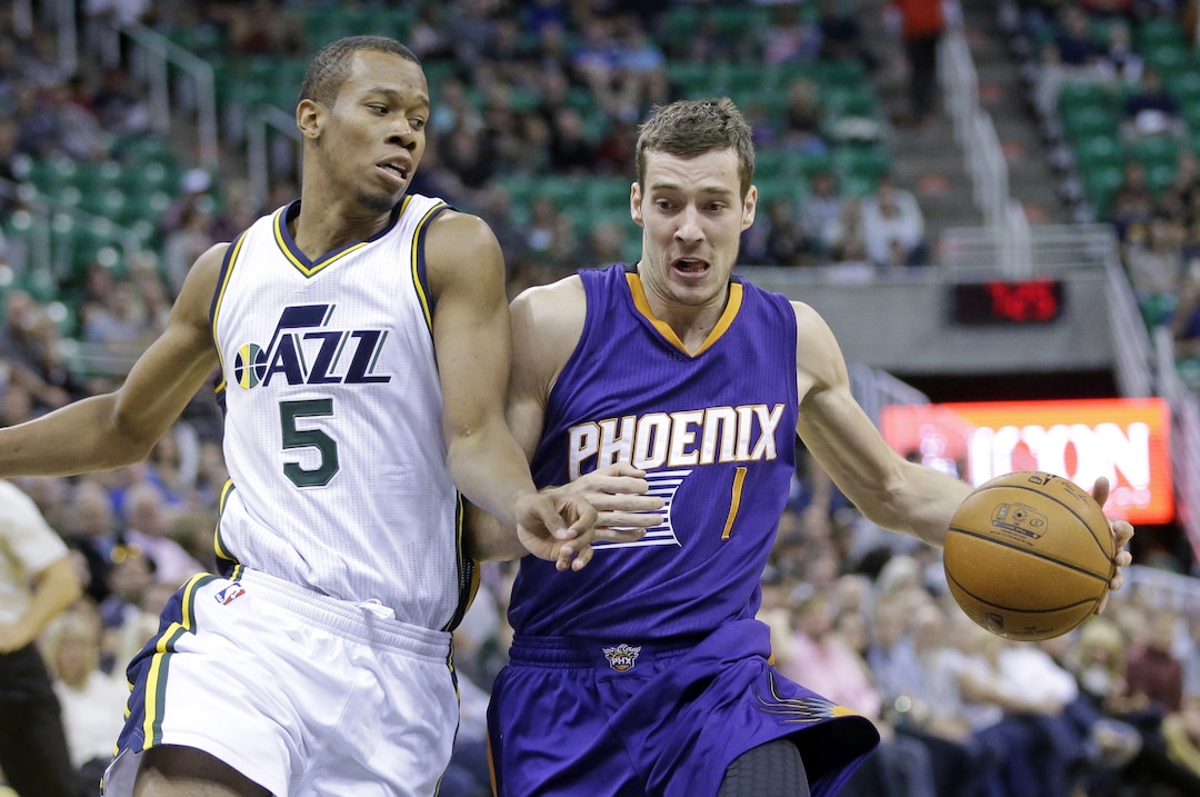 Phoenix Suns' Goran Dragic (1) drives to the basket as Utah Jazz's Rodney Hood (5) defends during the first half of an NBA preseason basketball game Friday, Oct. 24, 2014, in Salt Lake City. The Suns won 105-100. (AP Photo/Rick Bowmer)  