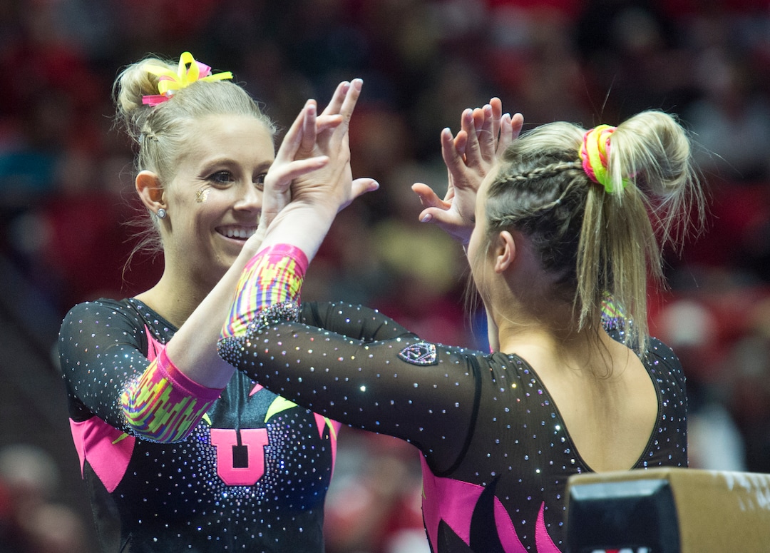 (Rick Egan  |  The Salt Lake Tribune)   Team mates congratulate MaKenna Merrell-Giles after her performance on the beam for Utah, in Gymnastics action Utah vs. Oregon State at the Jon M. Huntsman Center, Friday, January 19, 2018.