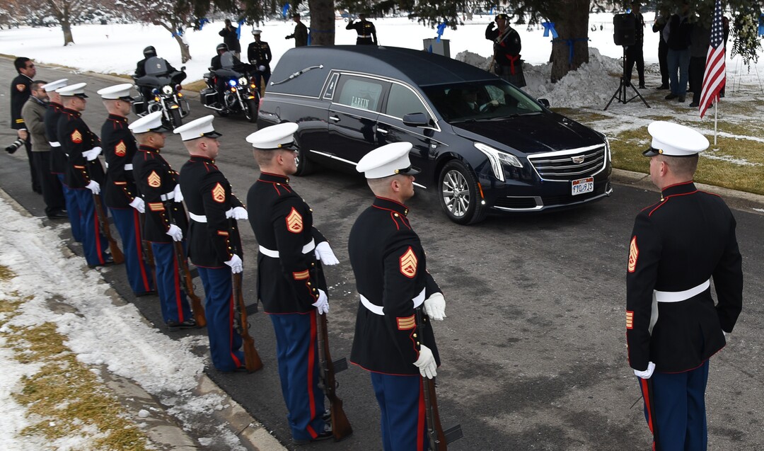 (Francisco Kjolseth  |  The Salt Lake Tribune)  The hearse carrying police officer David Romrell arrives as the Marine Corps stand at attention during funeral services at Larkin Sunset Gardens Cemetery in Sandy, Wed. Dec. 5, 2018.