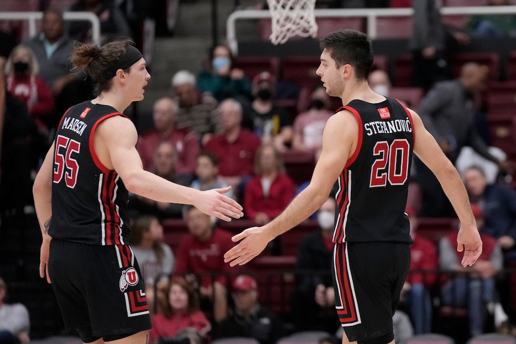 Utah guard Gabe Madsen (55) celebrates with guard Lazar Stefanovic (20) during the second half of an NCAA college basketball game against Stanford in Stanford, Calif., Saturday, Dec. 31, 2022. (AP Photo/Jeff Chiu)