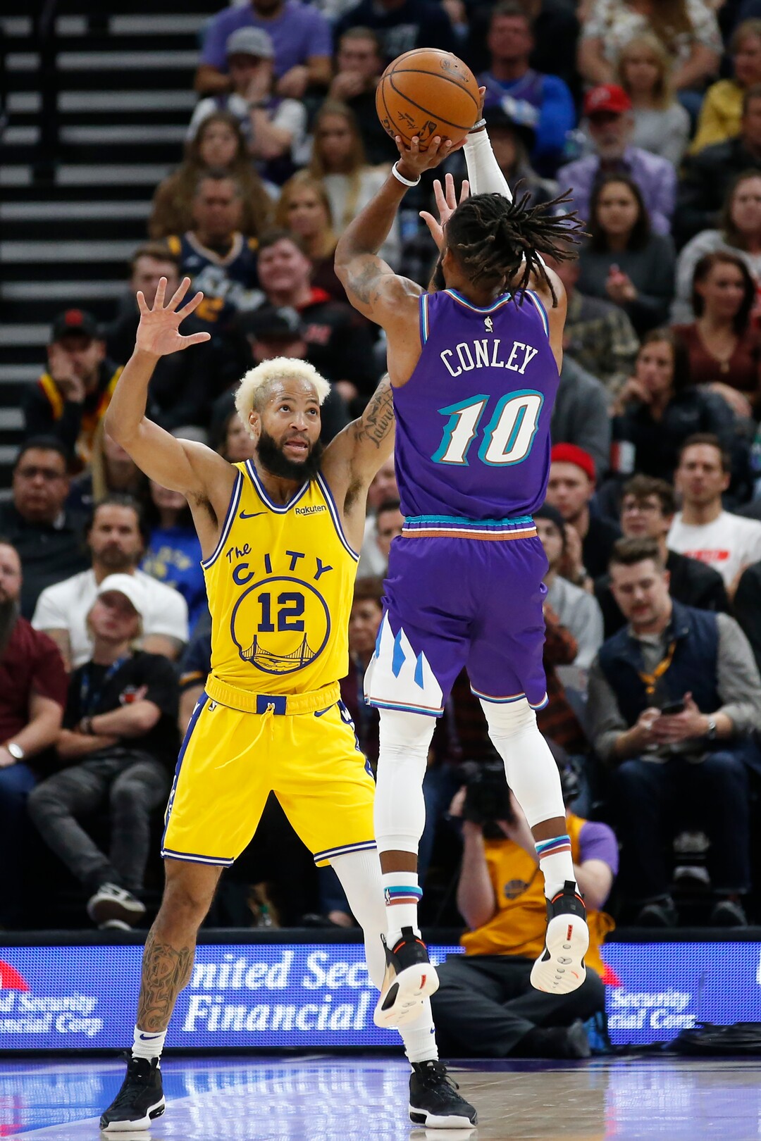 Utah Jazz guard Mike Conley (10) shoots as Golden State Warriors guard Ky Bowman (12) defends in the first half during an NBA basketball game Friday, Nov. 22, 2019, in Salt Lake City. (AP Photo/Rick Bowmer)
